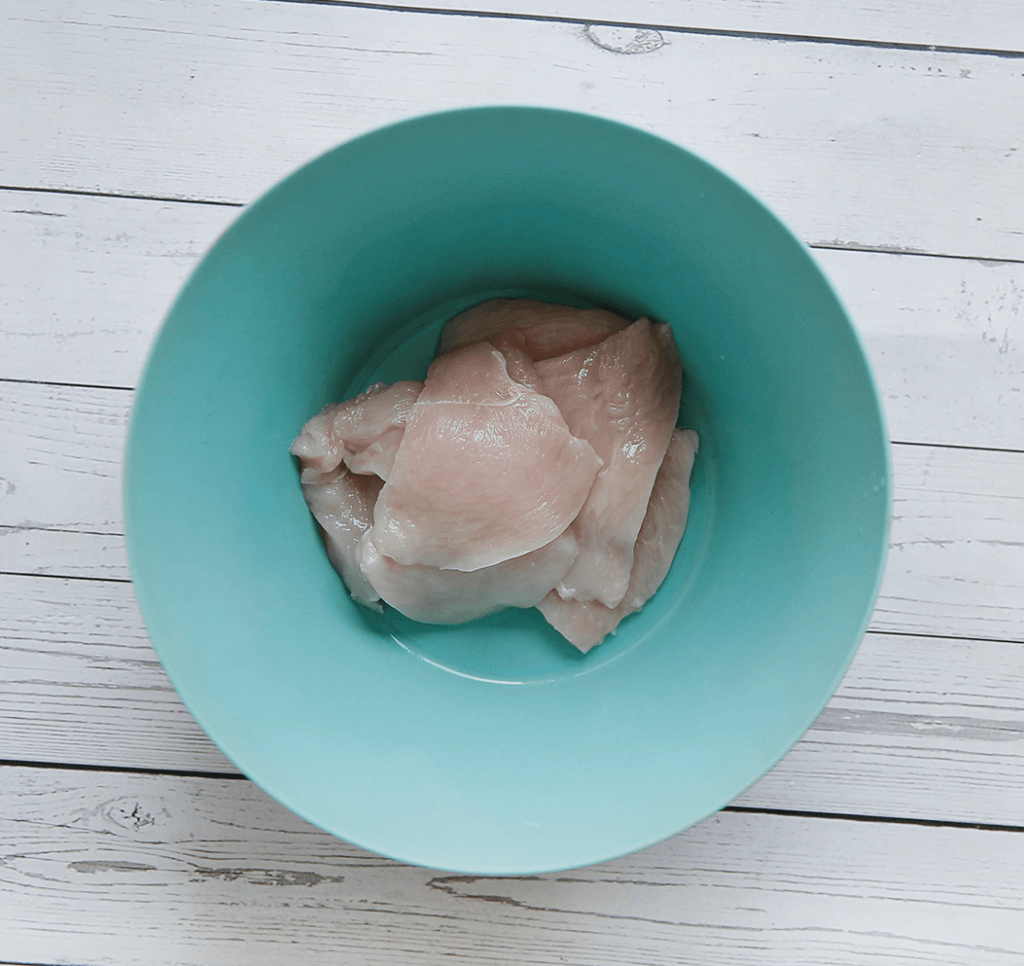 Snijd de kipfilet in dunne plakken.