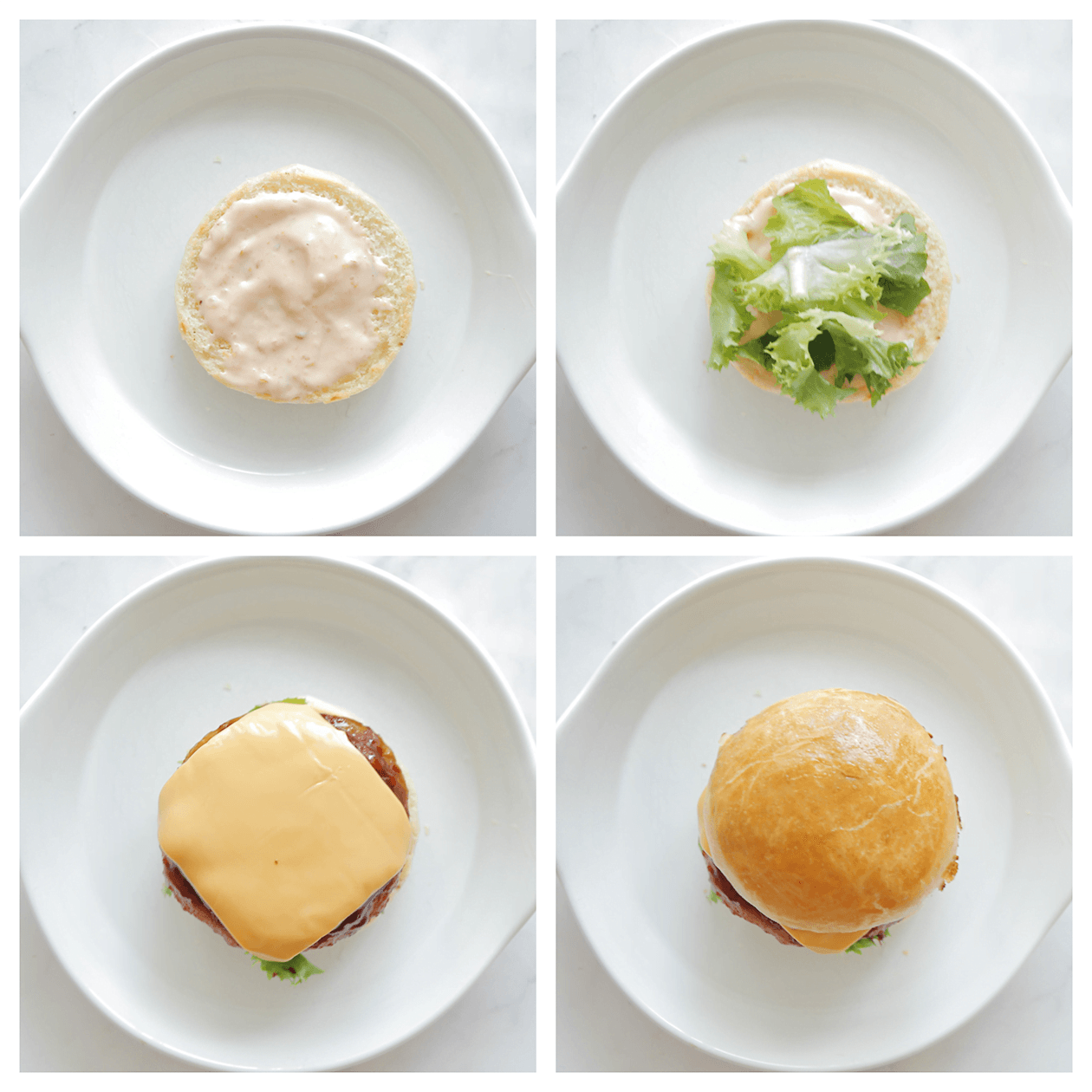 Kipburger op een broodje stapelen met saus, groenten en cheddar kaas