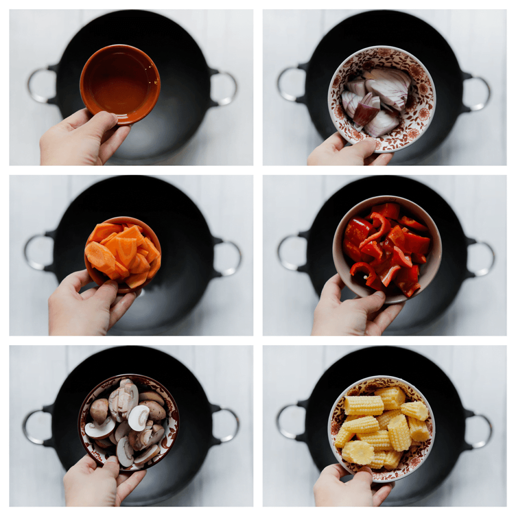 Verhit de zonnebloemolie in een wokpan op middelhoog vuur. Voeg de rode ui, wortel, rode puntpaprika, kastanjechampignons en babymaïs toe. 