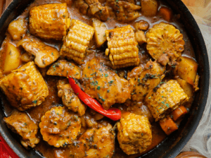 Kippendijen met maïskolven in saus