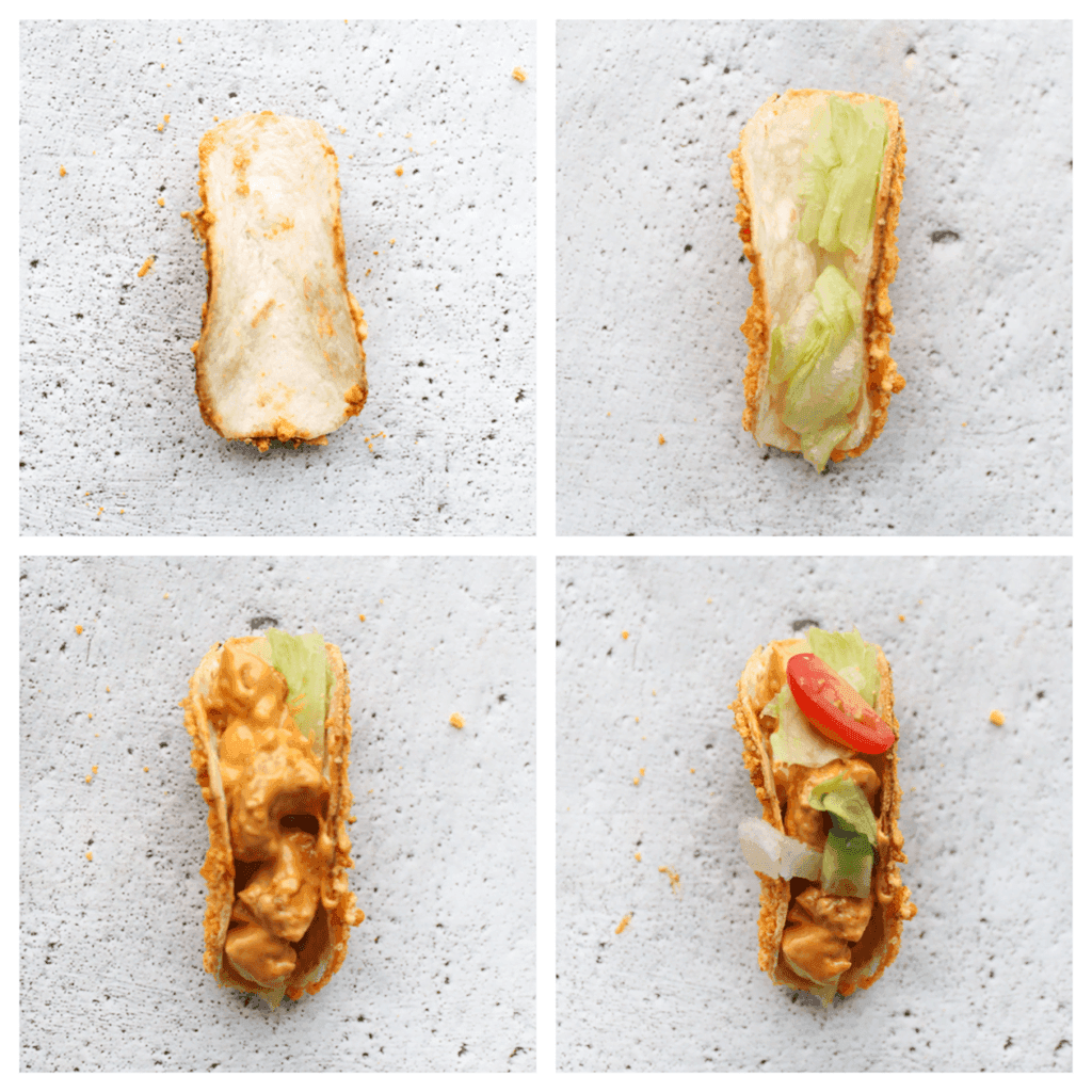 Neem een Bugles-taco en vul deze met ijsbergsla, kip en top het geheel af met de frisse groenten.