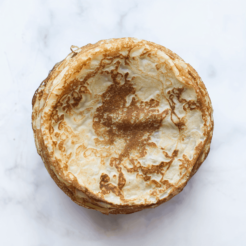 Herhaal het proces met de rest van het beslag tot alle pannenkoeken gebakken zijn. 