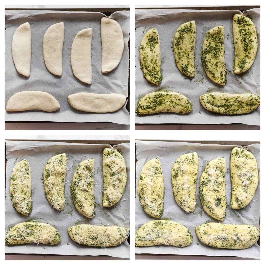 Leg het deeg op een bakplaat met bakpapier. Verdeel er een laagje groene pesto en geraspte kaas over. Laat het deeg 30 minuten rijzen, of tot het in omvang is verdubbeld.