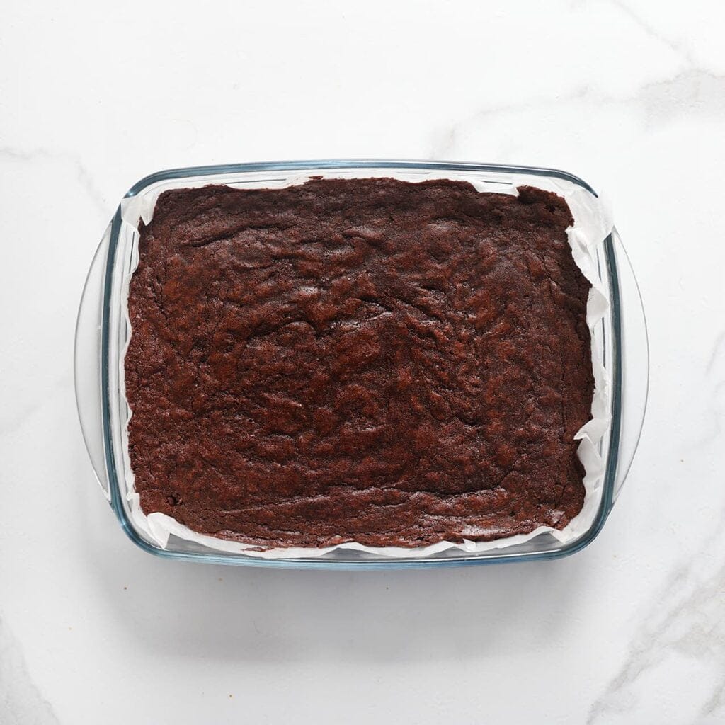 Plaats de brownie in een voorverwarmde oven op 175 ℃ en bak 20-30 minuten, of totdat de brownie gaar is. Houd de baktijd goed in de gaten, want elke oven werkt anders. Laat de brownie volledig afkoelen.