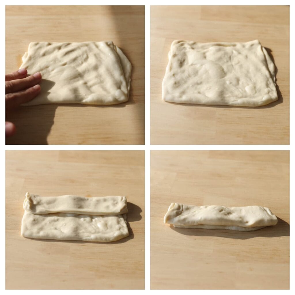 Druk het deeg iets plat. Vouw de boven- en onderkant naar het midden tot een rechthoek. Vouw daarna de zijkanten in tot een vierkant pakketje en druk lichtjes plat (20 cm). Vouw de boven- en onderkant naar het midden tot een rechthoek.